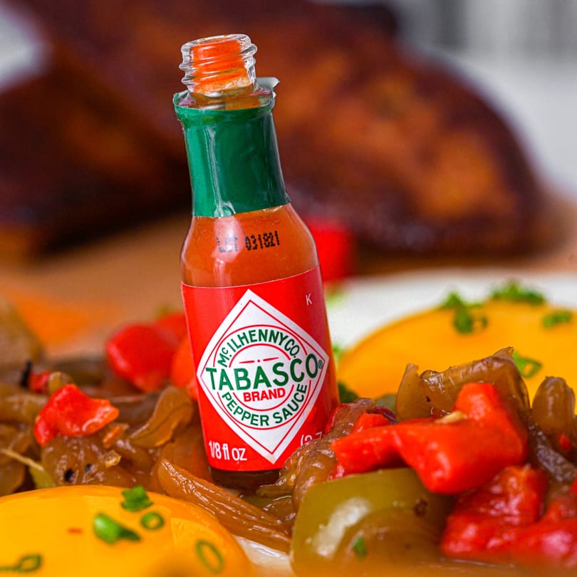 Tabasco hot sauce bottle on a breakfast plate with peppers and eggs at Bacon Bitch.